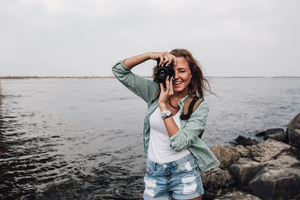 Girl takes photographs with vintage photo camera — Stock Photo, Image