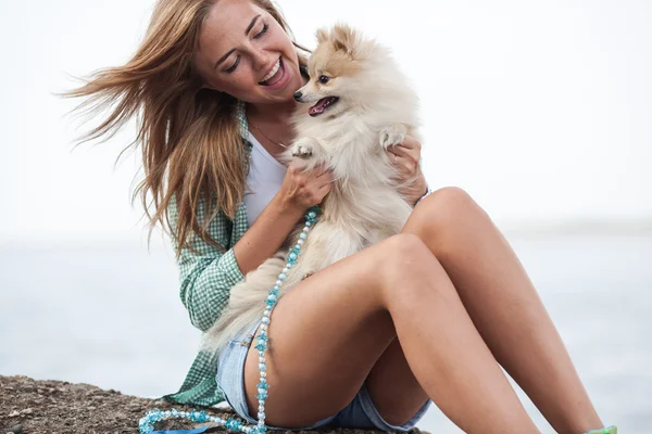 Jeune femme tient le chien à l'extérieur — Photo