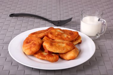 Kızarmış kek beyaz tabak, çatal ve bardak süt