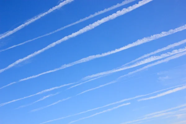 Contrails in een wolkenloze blauwe hemel — Stockfoto