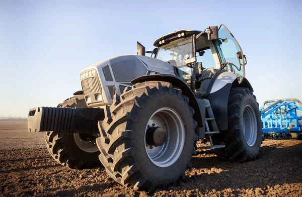 Closeup side view seeder on big wheels on ploughed field — Stock Photo, Image