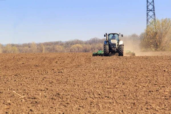 View of tractor sowing in field in spring — Stock Photo, Image