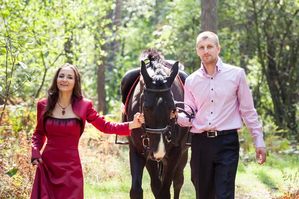 Casal feliz e cavalo — Fotografia de Stock