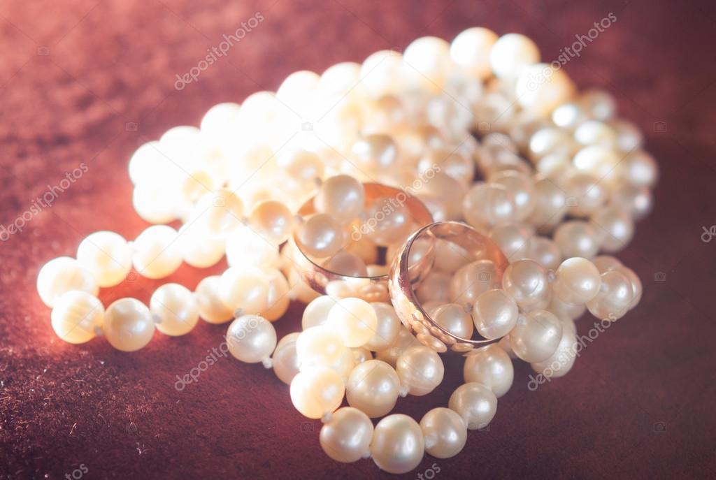 wedding rings on pearl necklace