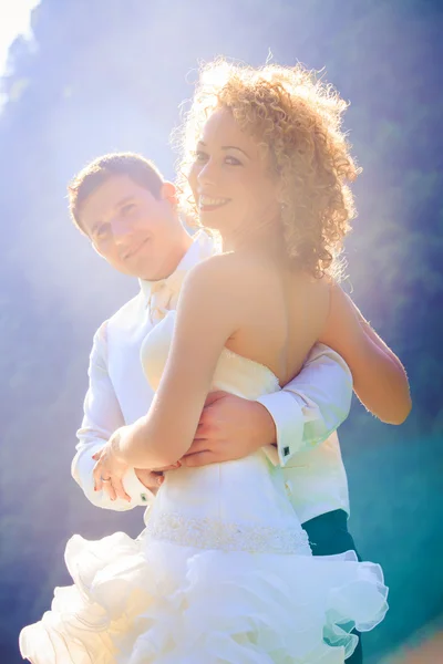 Blonde bride and handsome groom on boat — Stock Photo, Image