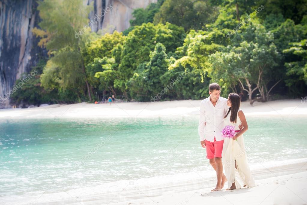 handsome groom walk with young brunette bride