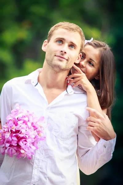 Brunette bride hugging her handsome groom — Stock Photo, Image