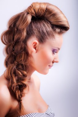 portrait sideview of blonde girl in elegant whimsical coiffure 