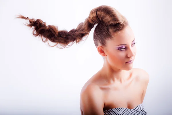 Blonde young girl in whimsical coiffure hanging in air — Stock fotografie