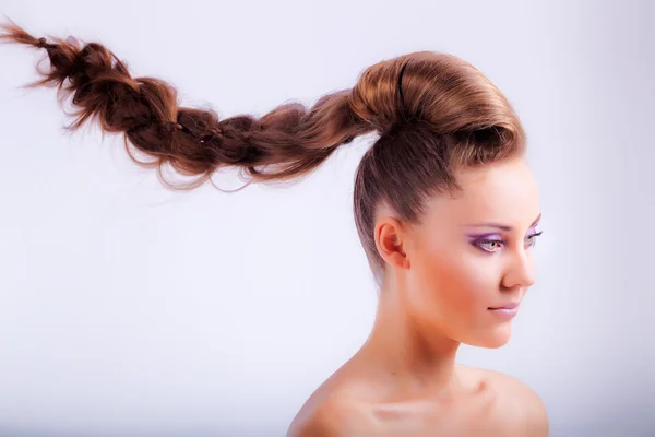 Blonde young girl in whimsical coiffure hanging in air Royalty Free Stock Images