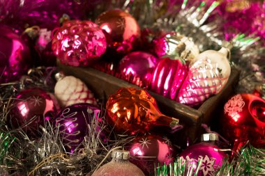 SSCB zamanından kalma kozalak ve kar taneleri şeklinde eski yılbaşı oyuncakları. Noel ağacında pembe, kırmızı ve kırmızı oyuncaklar ve ahşap bir kutuda gümüş süslemeler.