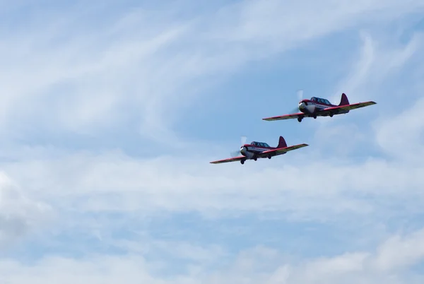 Two sports plane on a background of clouds