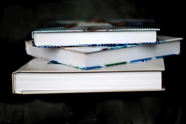 Pile of books on a black background — Stock Photo, Image