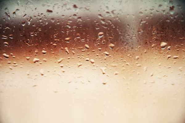 Achtergrond wazig druppels. Regenachtige glas. — Stockfoto