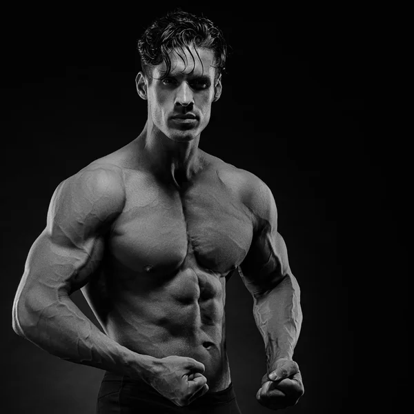 Strong Athletic Man showing muscular body and sixpack abs Stock Photo