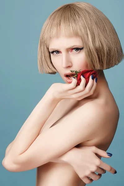 Beautiful blonde wig with a red rose in her hand — Stock Photo, Image