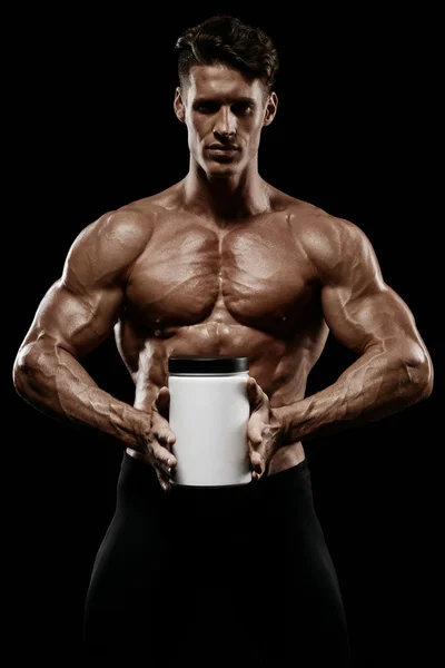 Muscular man holding jar with protein — Stock Photo, Image