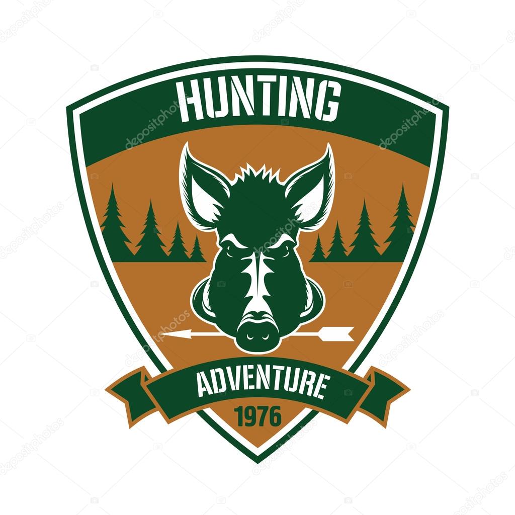 Brown triangular heraldic shield badge for hunting club design with a head of a wild hog with arrow in the mouth, flanked by fir trees and ribbon banner below