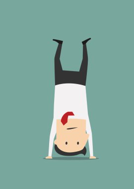 Cheerful businessman standing on his head