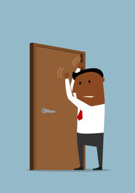 Businessman knocking at the closed door