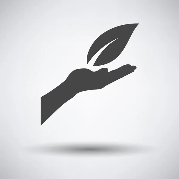 Ręka trzyma liść ikona — Wektor stockowy