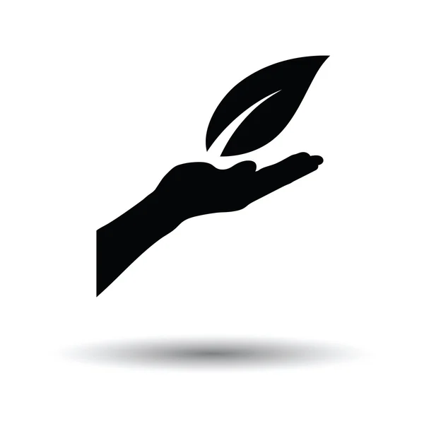Hand som håller bladet ikonen — Stock vektor