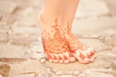 Henna On Womans Legs. Mehndi, application of henna as skin decor