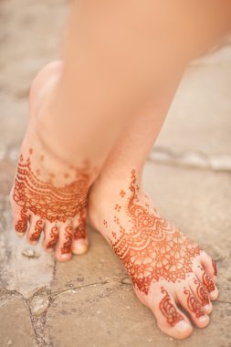 Henna On Womans Legs. Mehndi, application of henna as skin decor