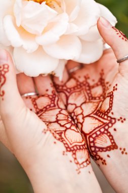 Mehndi tattoo. Woman Hands with black henna tattoos. India natio