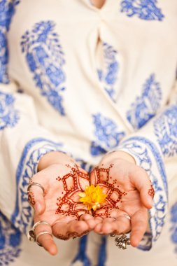 Mehndi tattoo. Woman Hands with black henna tattoos. India natio