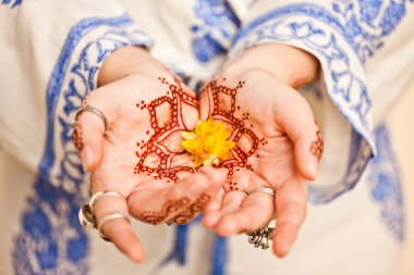 Mehndi tattoo. Woman Hands with black henna tattoos. India natio