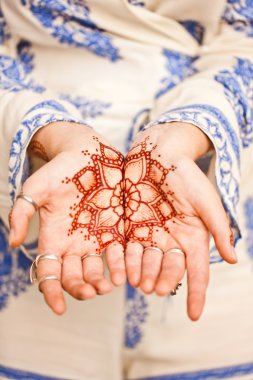 Mehndi tattoo. Woman Hands with black henna tattoos. India natio
