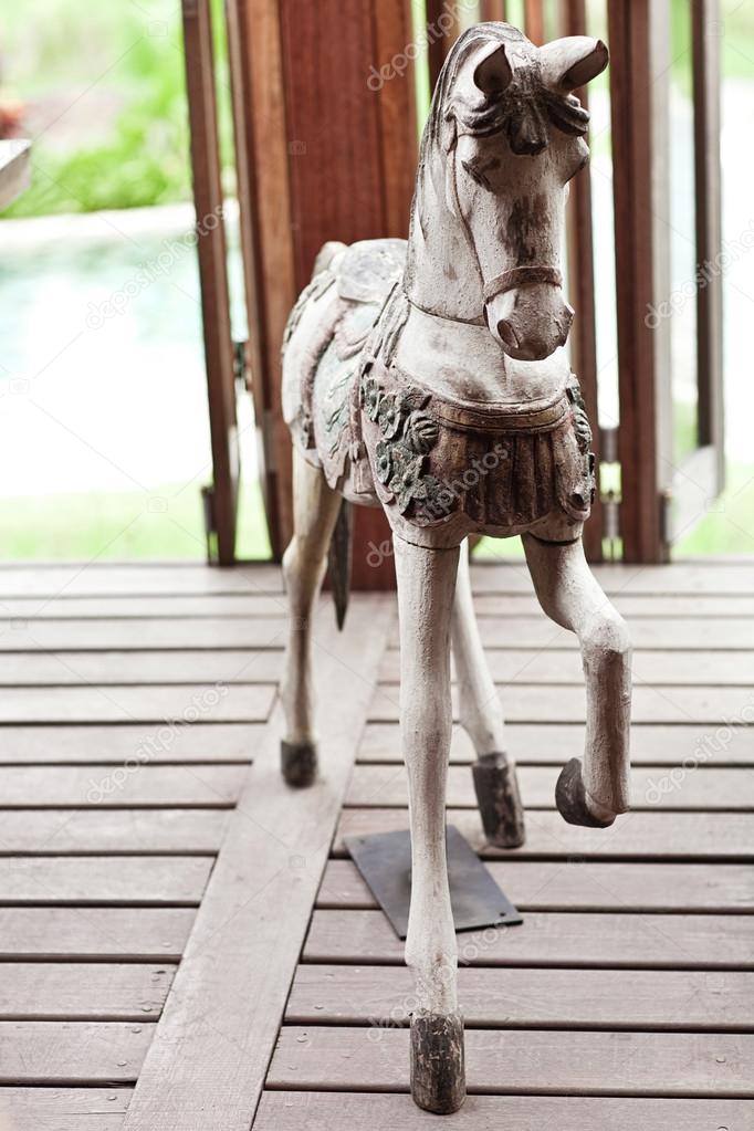 Hand made wooden vintage white horse standing on the wood floor