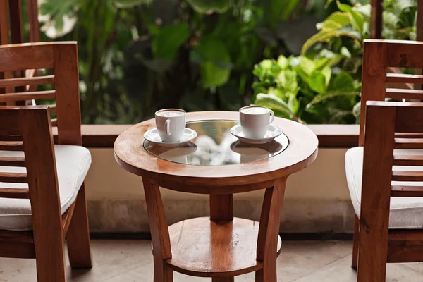 Two cups of coffee on restaurant terrace with afternoon sunlight — Stock Photo, Image