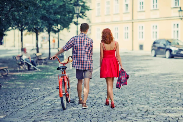 Couple walking on the street with bike. — Stock Photo, Image