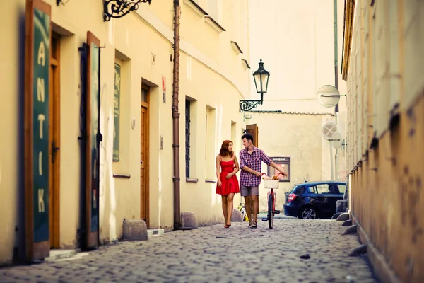 Couple walking on the street with bike. — Stock Photo, Image