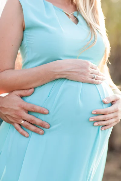 Close up of human hands holding pregnant belly — Stock Photo, Image