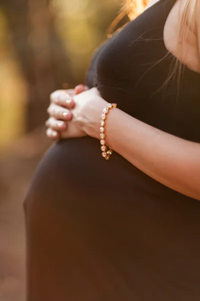 Close up of human hands holding pregnant belly — Stock Photo, Image