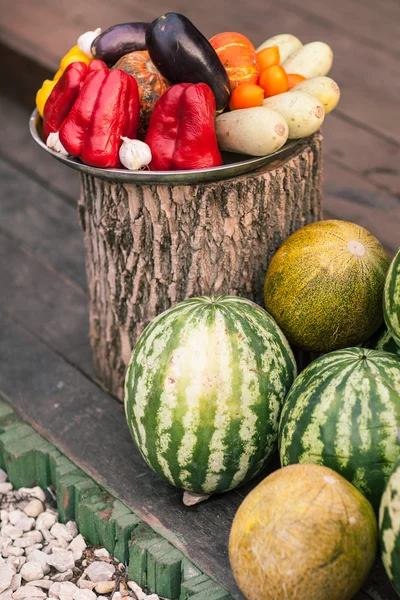 Group of fresh vegetables and fruit on big firewood — Stock Photo, Image