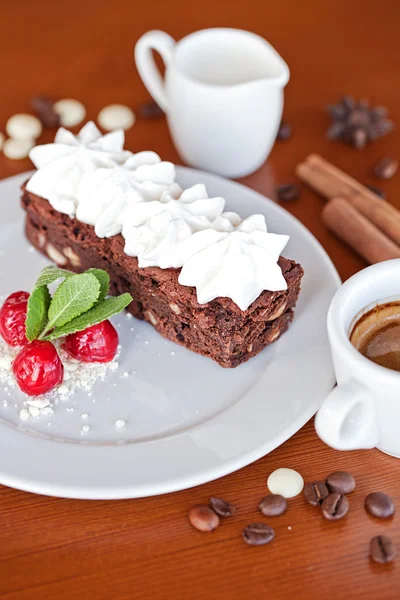 Brownie with cream cheese on a dark wood background — Stock Photo, Image