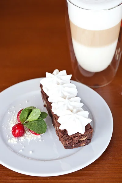 Brownie with cream cheese on a dark wood background — Stock Photo, Image