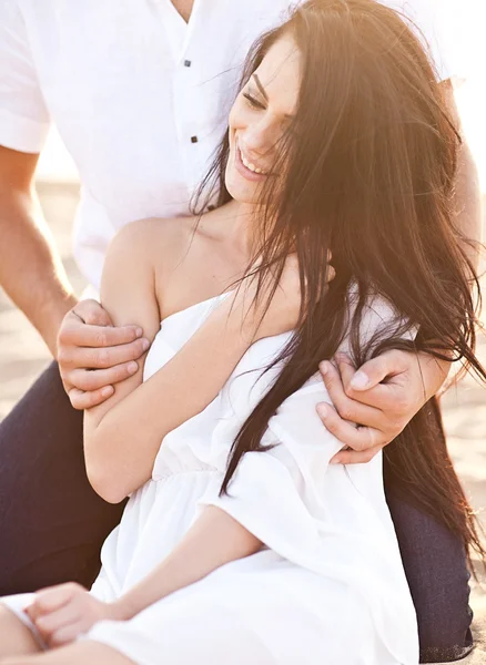 Lovely couple on sunset beach — Stock Photo, Image