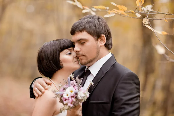 Glückliche Braut und Bräutigam beim Spaziergang im herbstlichen Wald — Stockfoto