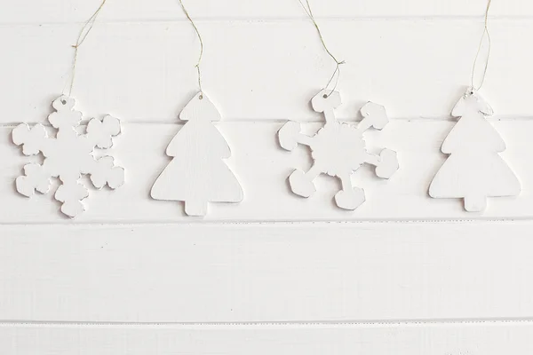 Wooden snowflakes and new year tree on vintage white wood background — Stock Photo, Image