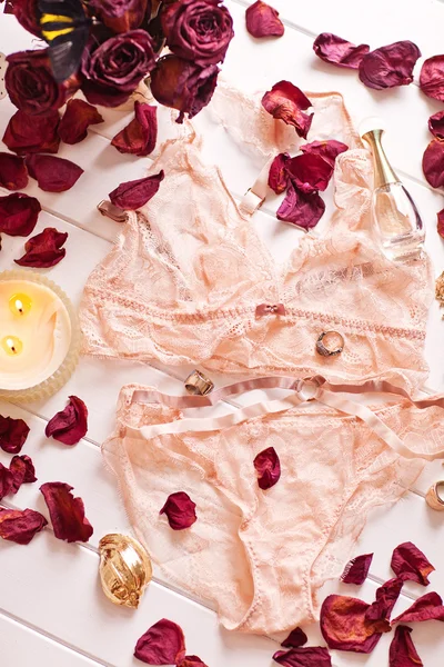 Tenderness peachys lingerie with roses petails, candle and accessories. Love mood. Stock Image
