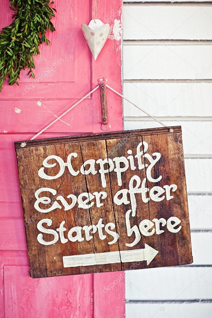 Valentine wreath and sign board on wooden vintage pink door