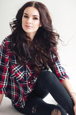 Genç çekici kadın stüdyoda poz kareleri alınmış gömlekli. Casual stile.