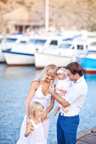 Happy family having fun walking on the mooring near yachts — Stock Photo, Image
