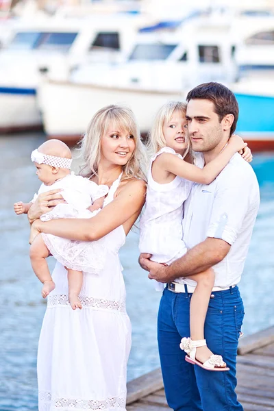 Happy family having fun walking on the mooring near yachts — Stock Photo, Image