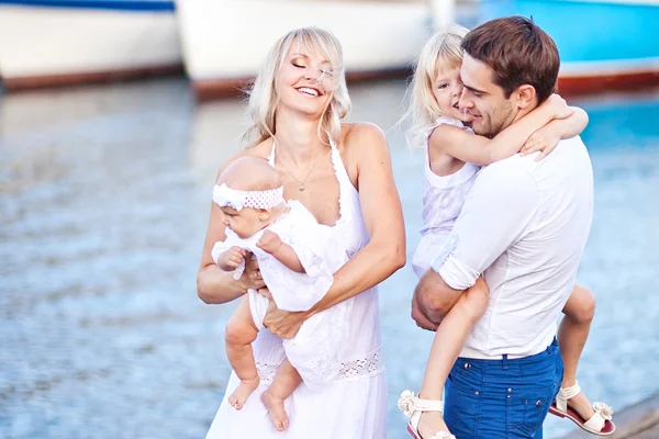 Happy family having fun walking on the mooring near yachts — Stock Photo, Image